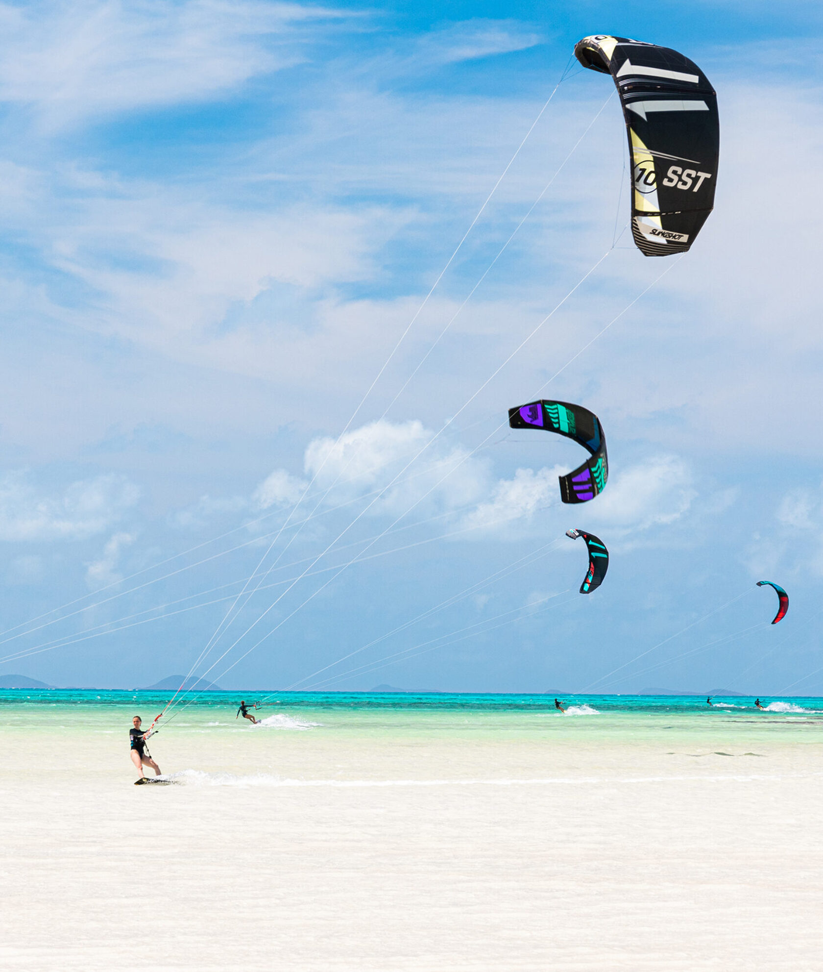 Kite surfers by the shore