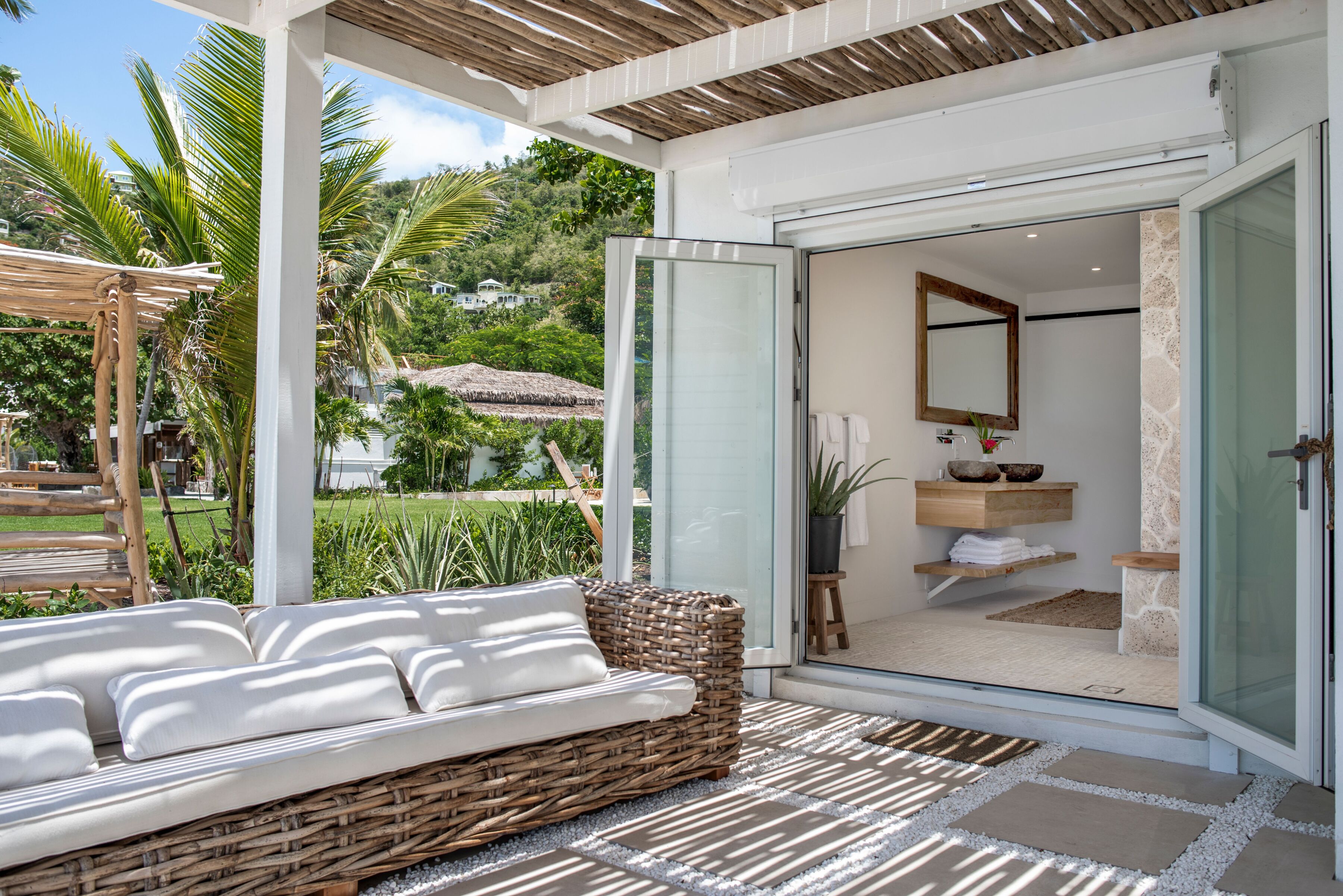 Private beachfront patio with pergola and luxury outdoor seating at the Oceanfront Suite, just steps from the white sands of Long Bay Beach with breathtaking Caribbean Sea and British Virgin Islands views.